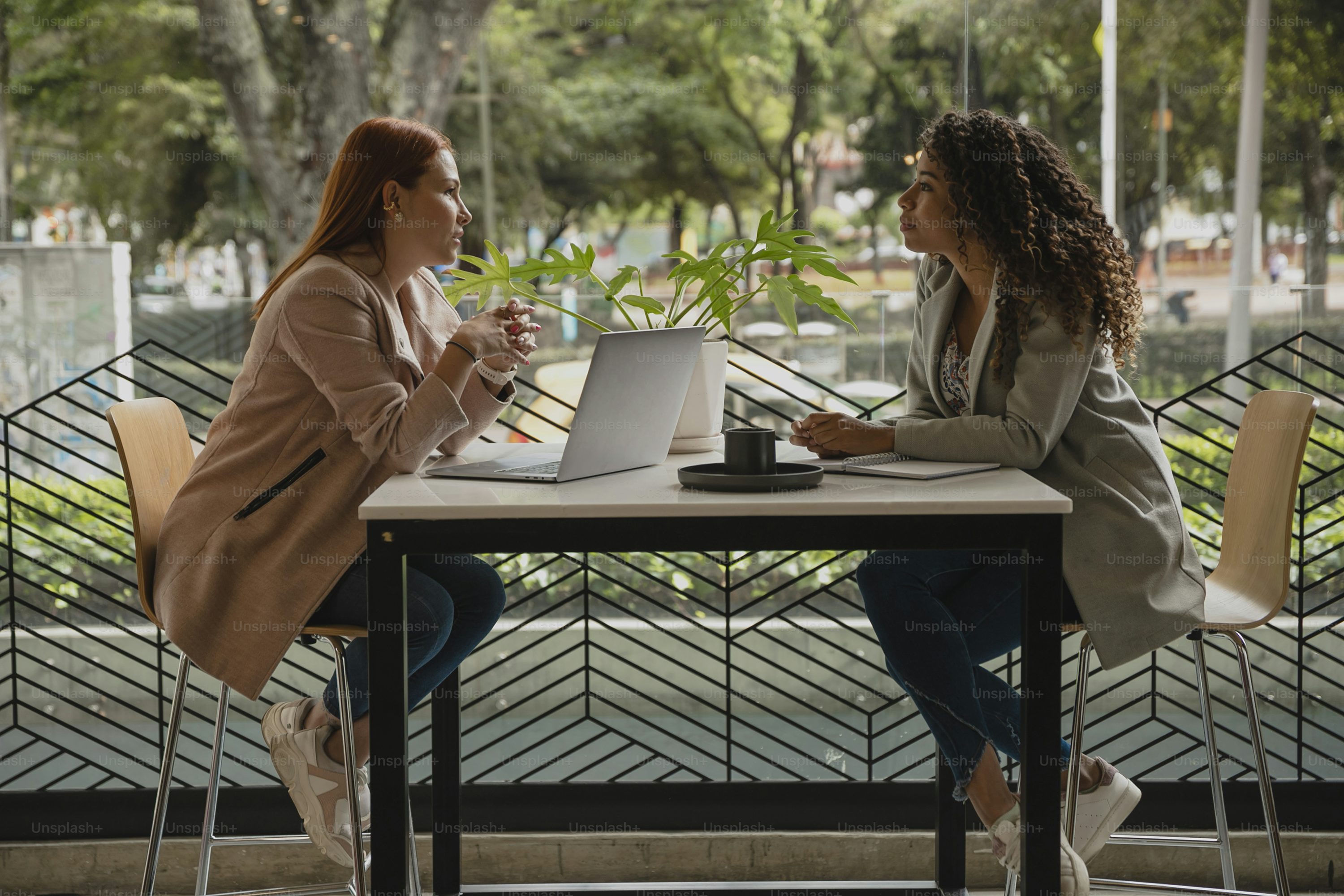 Two women having a warm, supportive conversation over coffee